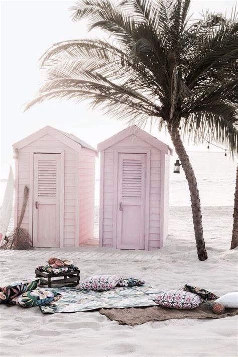 Download Beautiful Beach Huts Lined Up On A Sandy Shore Wallpaper