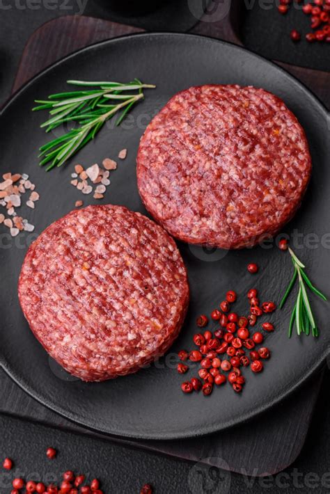 Fresh Raw Ground Beef Burger Patty With Salt And Spices Stock