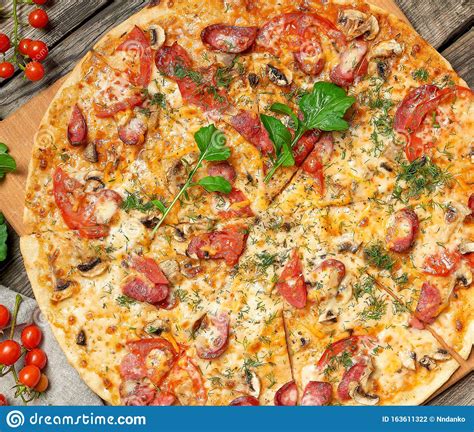 Baked Round Pizza With Smoked Sausages Mushrooms Tomatoes Cheese And