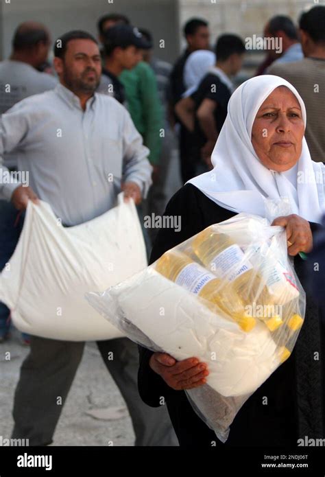 Palestinians Carry Bags Of Food Aid Distributed By The United Nations