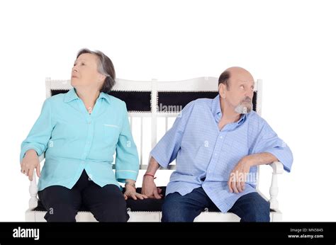 Annoyed Eldery Couple Ignoring Each Other And Sitting Back To Back On