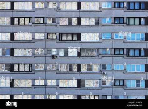 Texture Of An Apartment Building With Many Windows In The Afternoon