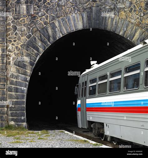 A Train Going Into A Tunnel Stock Photo Alamy