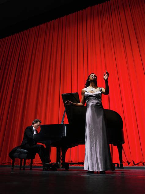 Woman Singing On Stage Accompanied By By Thomas Barwick