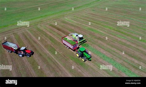 Aerial View Of Massey Ferguson 1880 Tractor Pulling Hay Wagon With Claas Jaguar 940 Forage