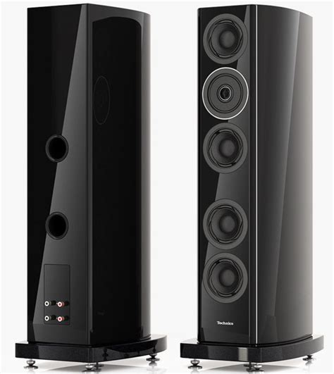 Two Black Speakers Sitting Side By Side On Top Of Each Other With One