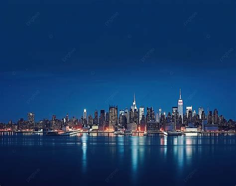 New York City Skyline Over Body Of Water At Night Background River