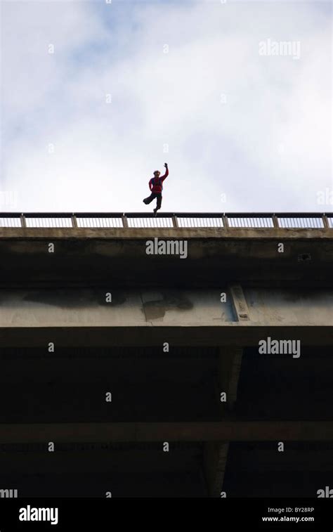 A man jumping off a bridge for a BASE jump Stock Photo - Alamy