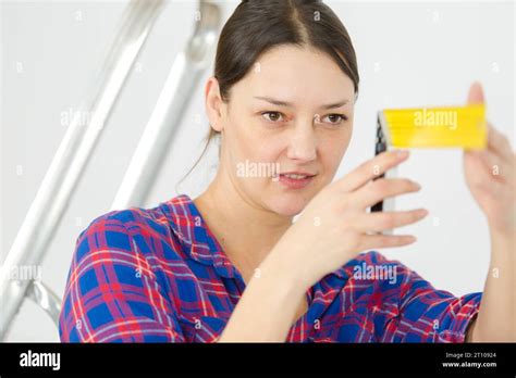portrait  woman inspecting  object stock photo alamy