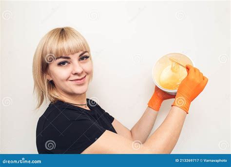 Shugaring Master Woman Stirring Sugar Paste For Hair Removal Stock