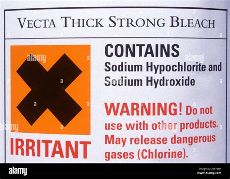 Hazard warning label on bottle of bleach sodium hypochlorite hydroxide ...