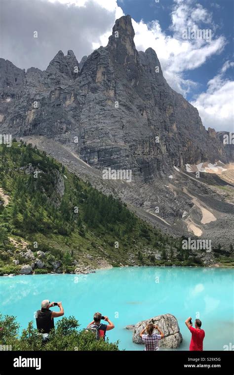 Hikers Taking Photos Of Lago Di Sorapis Dolomites Italy Stock Photo