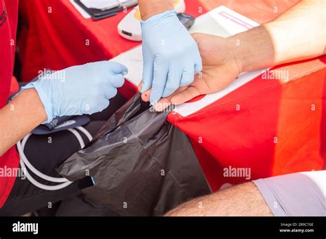 Nurse Wearing Gloves With A Patient Doing A Pin Prick Test On The