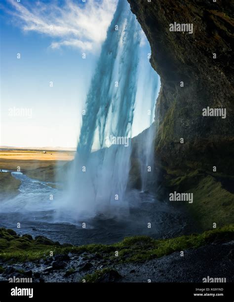 Cave behind Seljalandsfoss Waterfall in Iceland with long Exposu Stock ...