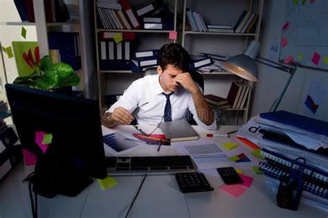 The Man Businessman Working Late Hours In The Office Stock Image