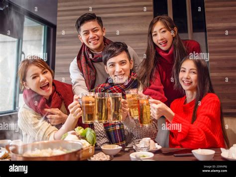 Happy Friends Drinking And Toasting Beer At Hot Pot Restaurant Stock Photo Alamy