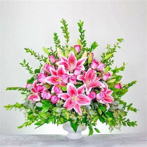 A Condolence Flower Arrangement Of Lavender Roses And Stargazer Lilies