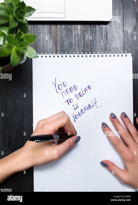 Female Hands Writing Motivational Message In A Notebook Stock Photo Alamy