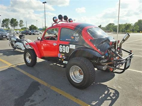 A Red And Black Vehicle Parked In A Parking Lot