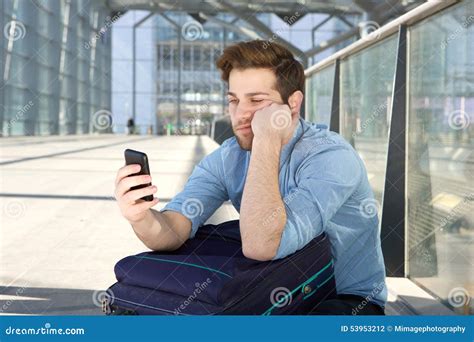 Man Waiting At Airport With Bored Expression On Face Stock Photo