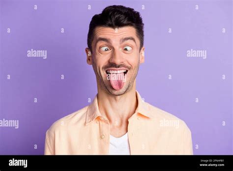 Portrait Of Funny Brunet Hair Guy Tongue Out Wear Peach Shirt Isolated