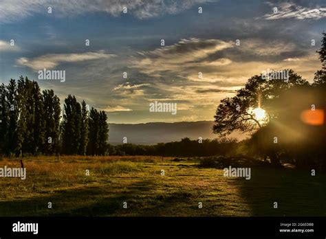 Sunset In A Green Field With A Mountain Background In Amaicha Del Valle