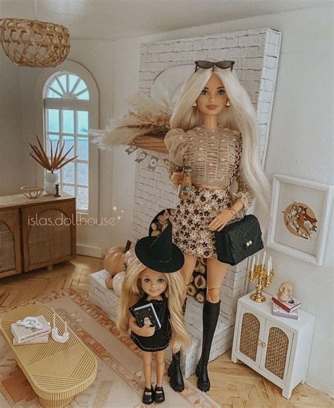 Two Dolls Standing Next To Each Other In A Living Room