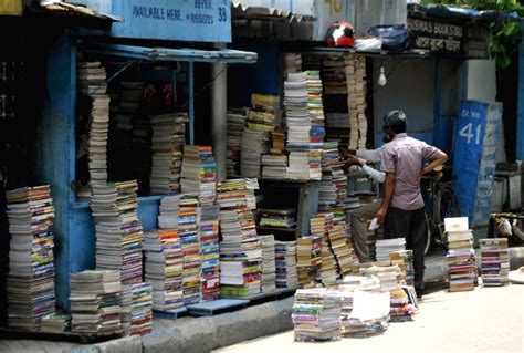 Customers purchase books from book stalls at College street Book market ...