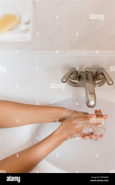 African American Woman Washing Hands With Soap Stock Photo Alamy