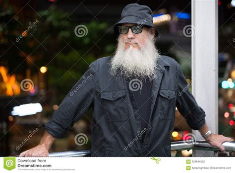 Mature Bearded Tourist Man At Footbridge With View Of The City Stock