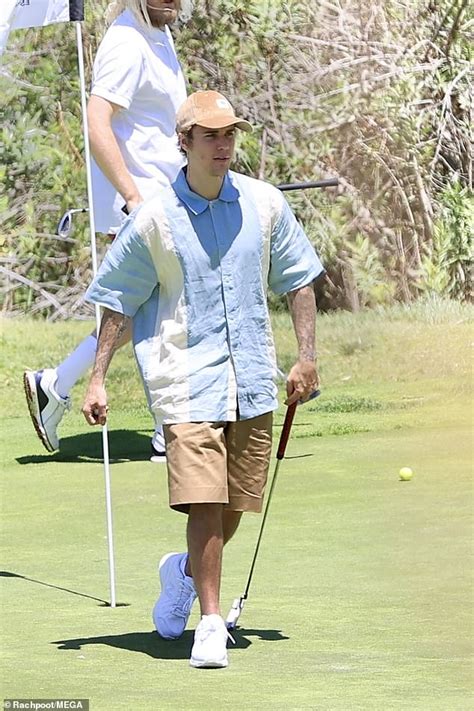 Justin Bieber Practices His Golf Swing During A Round On The Course