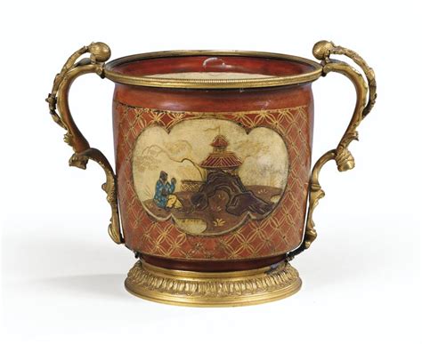 An Ornately Decorated Vase With Gold Trimmings On The Handles And Sides