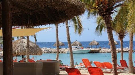 Premium Photo Deck Chairs And Thatched Roof Parasols At Beach