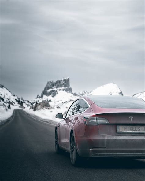 A Red Electric Car on a Road during Winter · Free Stock Photo