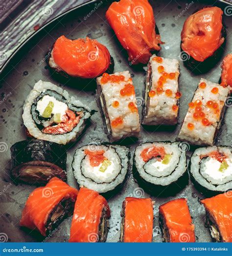 Various Kinds Of Sushi Served On Dark Plate Macro Stock Photo Image