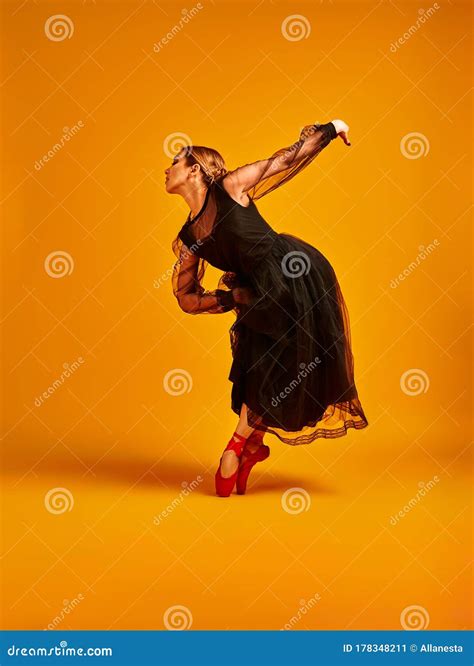 Ballet Dancer Or Classic Ballerina Dancing Isolated On Yellow