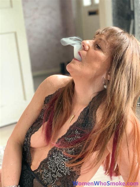 Badass Mature Woman Poses In Her Lingerie While Smoking A Cigarette