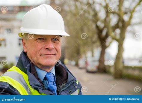 Portrait Of Construction Worker Wearing White Safety Helmet And High