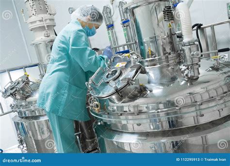 Pharmaceutical Factory Woman Worker In Protective Clothing Operating