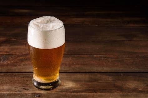 Premium Photo Glass Beer On Wooden Table