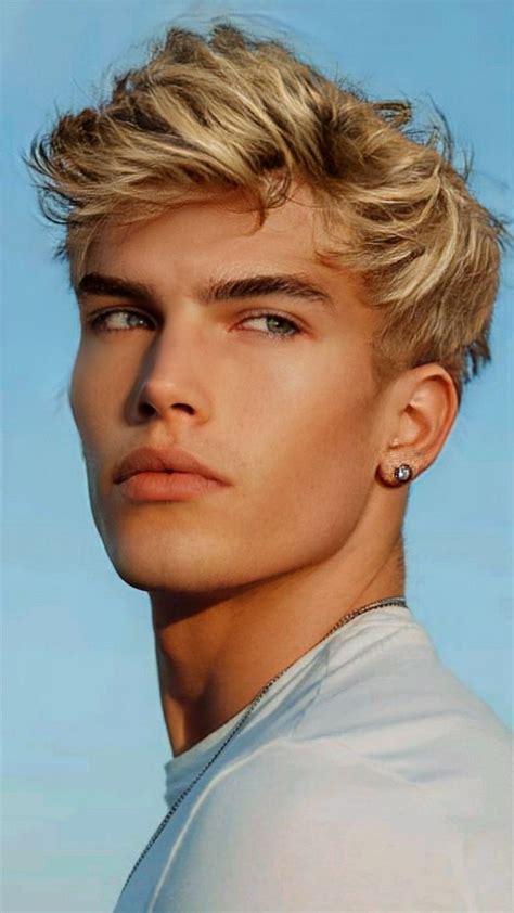 A Young Man With Blonde Hair And Piercings