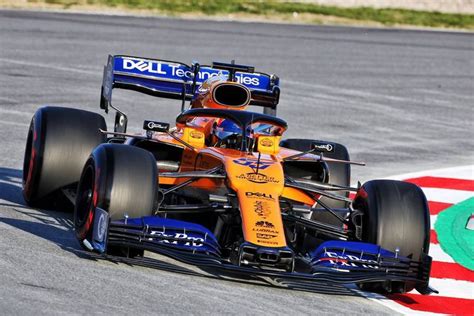 An Orange And Blue Race Car Driving On A Track