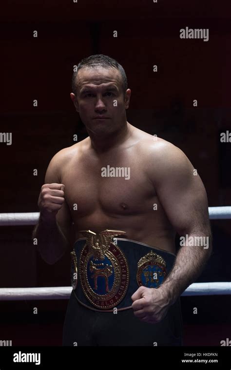 Portrait Of Muscular Professional Kick Boxer With His Championship Belt