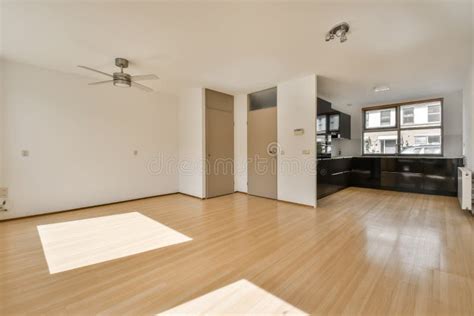 An Empty Living Room with Wood Floors and a Kitchen Stock Image - Image ...