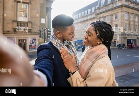 Cheerful Couple In Town Face To Face Taking Selfie With Mobile Phone