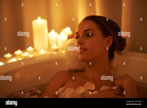 Soothed By The Ambiance And A Hot Bath Cropped Shot Of A Gorgeous Woman Relaxing In A Candle