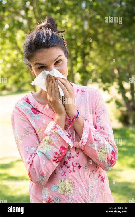 Pretty Brunette Blowing Her Nose Stock Photo Alamy