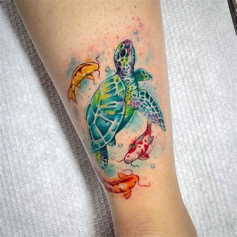 A Woman S Leg With A Turtle And Fish Tattoo On It