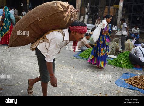 Manual Worker carrying Potato sack on his back Stock Photo - Alamy