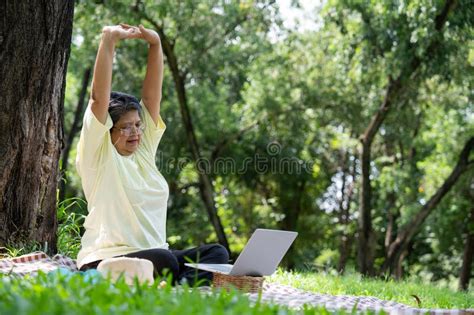 Happy Asian Senior Woman Using Laptop For Working Online Outside Office